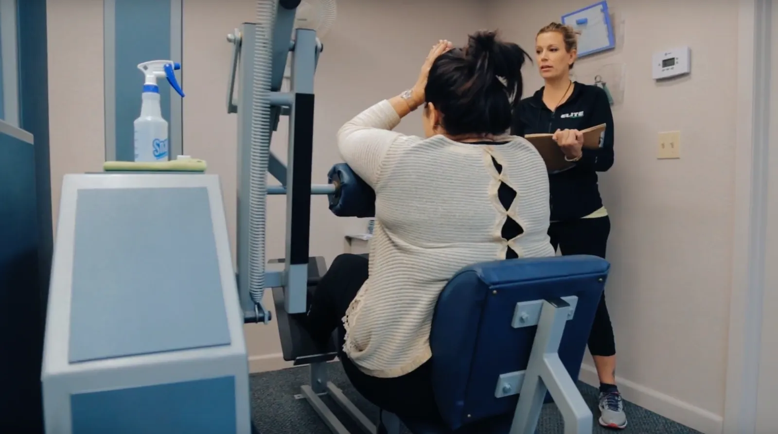 Trainer supporting a client one-on-one at Elite Strength & Fitness in Winter Park